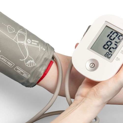 person using blood pressure monitor