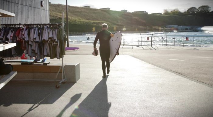 surfer walking with surf board