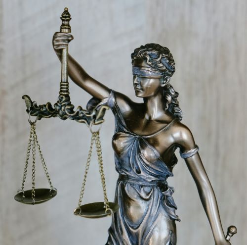 statue of woman hold scales to represent law