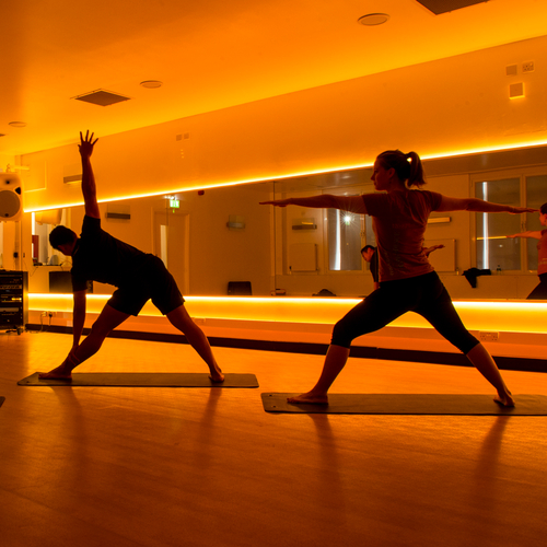 two people practicing yoga