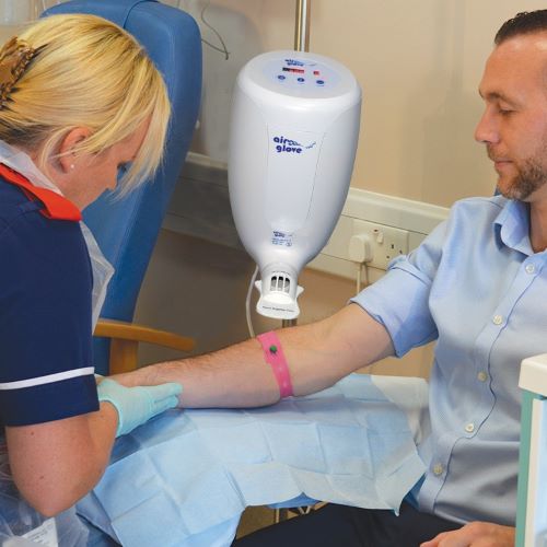 Nurse with a patient putting glove on