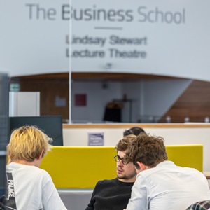 3 stduents sitting at Edinburgh Napier's Business School