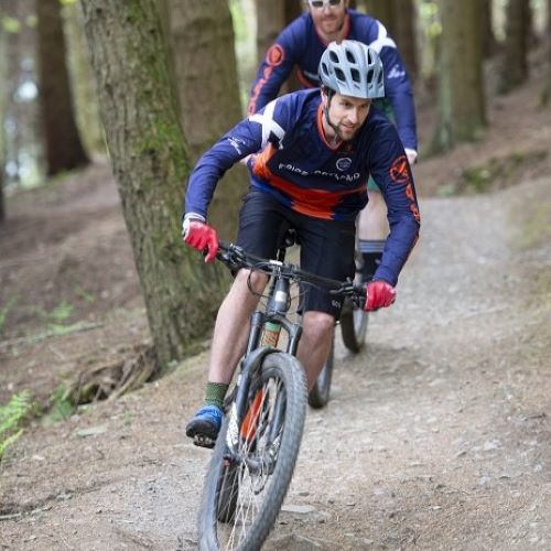 man on mountain bike in forest
