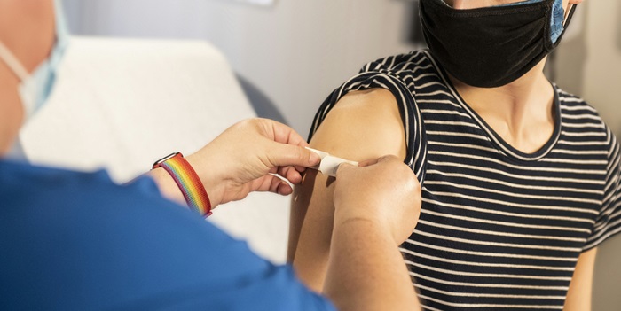 nurse putting a plaster on arm of patient